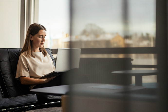 En tjej på kontoret med en laptop