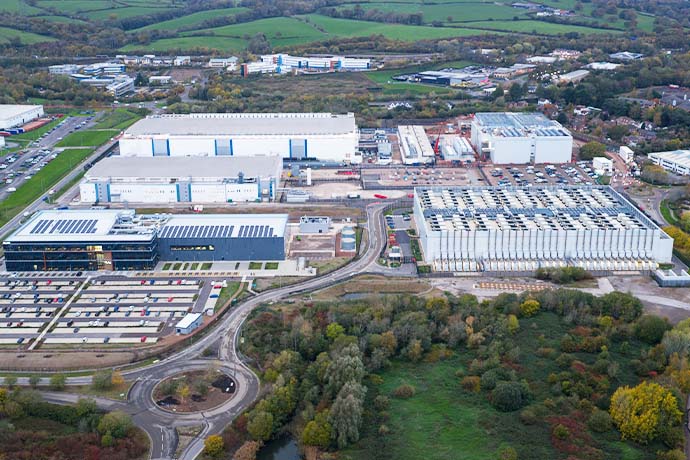 The image shows a drone view of industrial buildings
