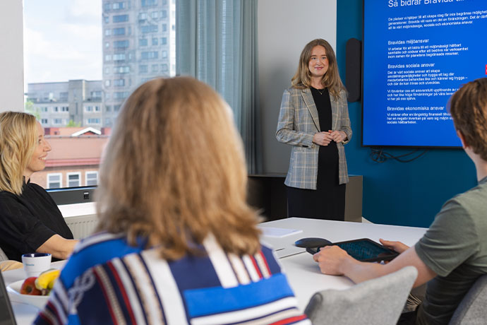 The image shows participants during a meeting in an office environment
